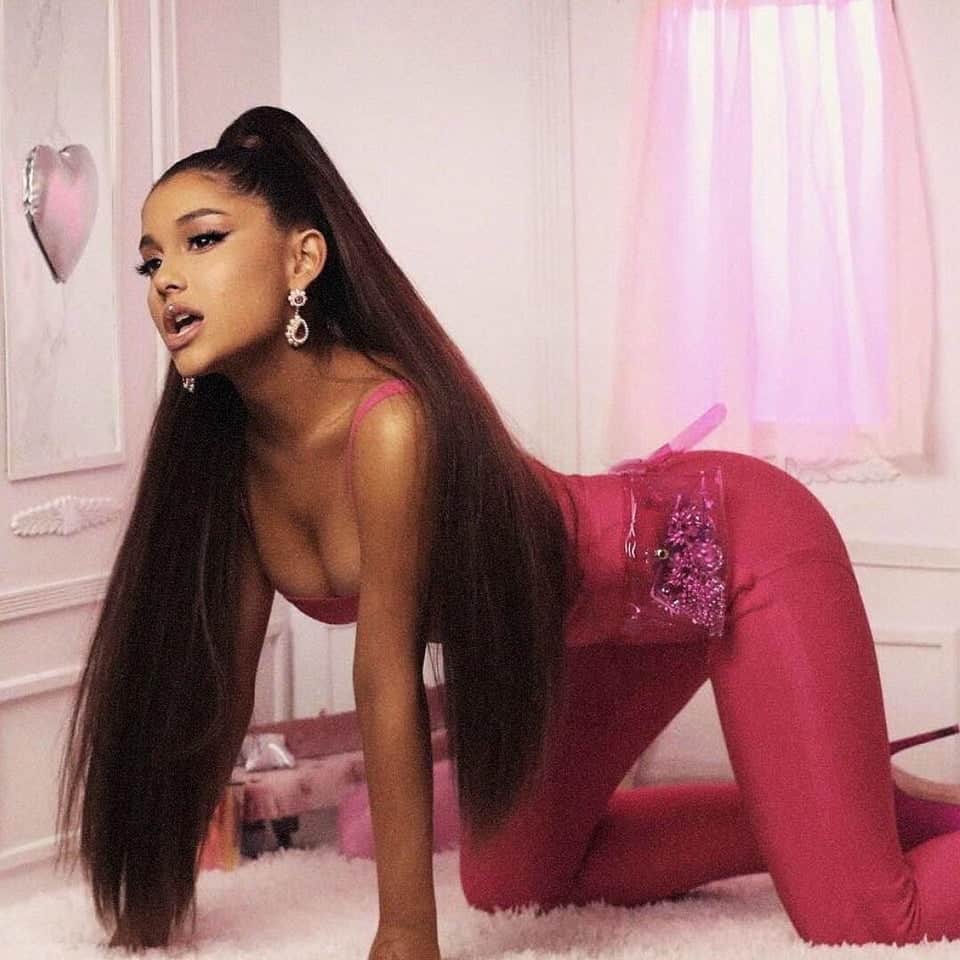 ariana grande pink latex bodysuit kneeling pose